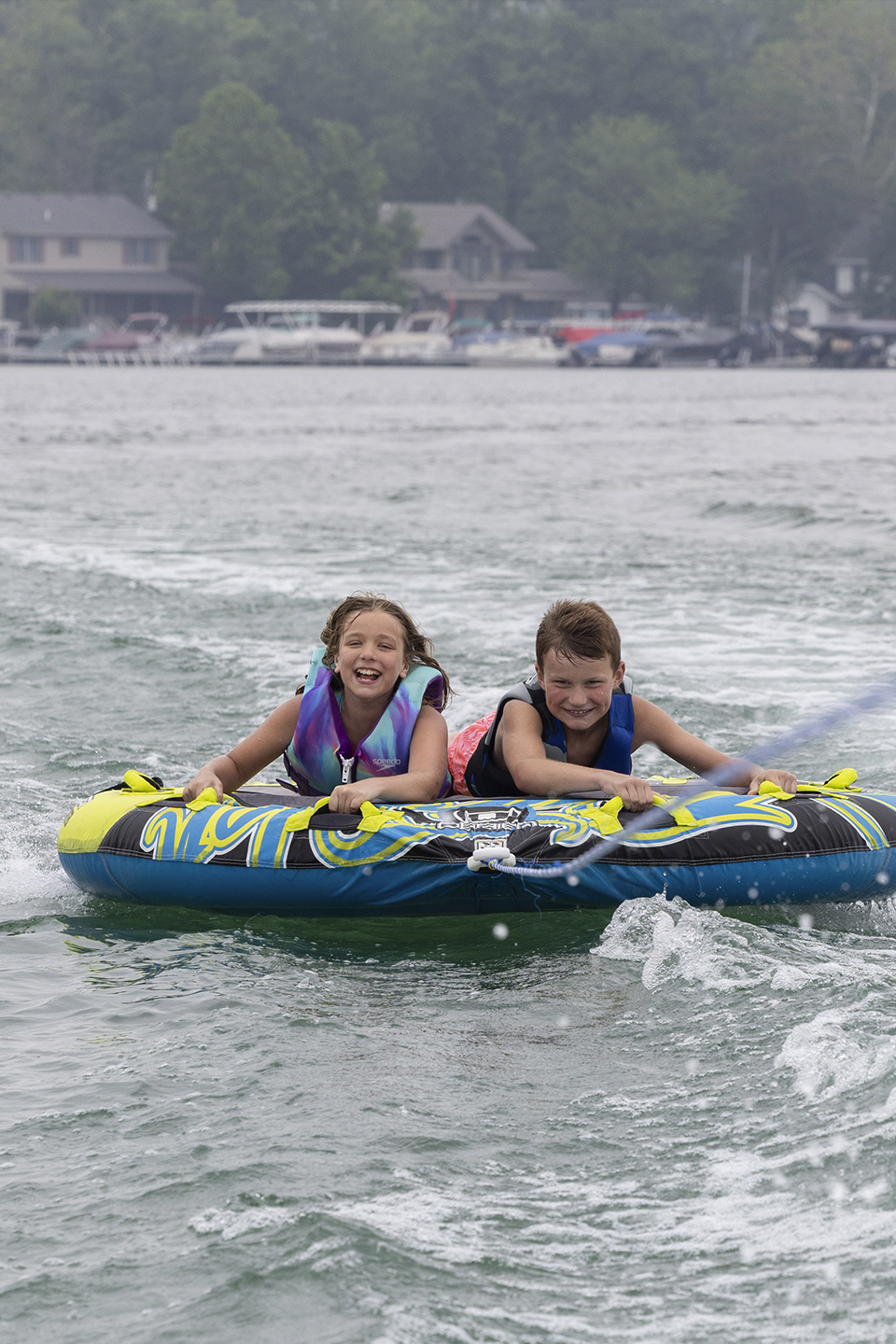 Kids tubing behind Alera pontoon